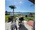 Waterfront home featuring a patio, expansive lawn, a dock, and a charming gazebo overlooking the water at 2110 Society Dr, Holiday, FL 34691