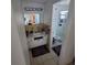 Compact bathroom with a white vanity, a well-lit mirror, and a glass-enclosed shower at 2110 Society Dr, Holiday, FL 34691