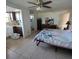 Cozy bedroom featuring a floral bedspread and an adjacent kitchenette and bathroom at 2110 Society Dr, Holiday, FL 34691