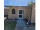 Welcoming front entrance with unique arched window and a well-maintained walkway at 2110 Society Dr, Holiday, FL 34691