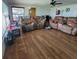 Spacious living room with laminate flooring and comfortable sofas at 2110 Society Dr, Holiday, FL 34691