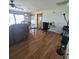 Comfortable living room with laminate flooring, sofas, and a ceiling fan at 2110 Society Dr, Holiday, FL 34691