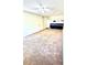 Bright living room featuring neutral carpeting, white walls, and ceiling fan at 2302 Maki Rd # 24, Plant City, FL 33563