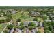 An aerial view of the golf course and clubhouse with mature trees, scenic landscaping and parking at 23734 Coral Ridge Ln, Land O Lakes, FL 34639
