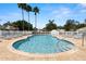 Community pool featuring clear water, safety railings, and poolside lounge seating at 23734 Coral Ridge Ln, Land O Lakes, FL 34639
