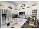 Spacious kitchen featuring stainless steel refrigerator, white cabinetry, granite counters, and sleek appliances at 23734 Coral Ridge Ln, Land O Lakes, FL 34639