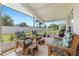 Relaxing screened patio with comfortable wooden seating and a view of the fenced-in backyard at 23734 Coral Ridge Ln, Land O Lakes, FL 34639