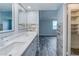 Well-lit bathroom with dual sink vanity, modern faucets, and a view to the adjacent bedroom at 2618 Cove Cay Dr # 801, Clearwater, FL 33760