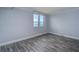 This bedroom features hard surface floors, light gray walls and a window with water view at 2618 Cove Cay Dr # 801, Clearwater, FL 33760