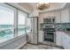 White kitchen with stainless steel appliances and bright natural light at 2618 Cove Cay Dr # 801, Clearwater, FL 33760