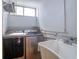 Functional laundry area equipped with washer, dryer, and utility sink at 2618 Cove Cay Dr # 801, Clearwater, FL 33760
