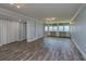 Bright living room featuring hard surface floors and large windows with water views and built-in shelving at 2618 Cove Cay Dr # 801, Clearwater, FL 33760
