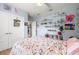 Bright bedroom features decorative shelving, a ceiling fan, and double door closets at 2623 57Th S St, Gulfport, FL 33707