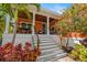 Charming home with a welcoming front porch, wooden railings, and well-maintained landscaping at 2623 57Th S St, Gulfport, FL 33707