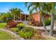 Charming home boasts tropical landscaping and a welcoming front porch with white pillars at 2623 57Th S St, Gulfport, FL 33707