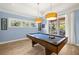 Bright game room featuring an attractive pool table, windows and a slider to the outside at 2623 57Th S St, Gulfport, FL 33707