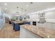 An open white kitchen and living room with custom cabinetry at 2623 57Th S St, Gulfport, FL 33707