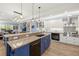 Open kitchen boasts a large island with granite countertops, a Wolf range, and views of the living area at 2623 57Th S St, Gulfport, FL 33707