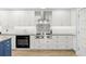 This gourmet kitchen features white cabinets, granite countertops, stainless steel appliances, and a Wolf range at 2623 57Th S St, Gulfport, FL 33707