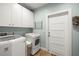 Well-equipped laundry room with washer, dryer, and ample storage space at 2623 57Th S St, Gulfport, FL 33707
