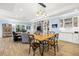 Open floorplan includes a large wooden table and a living room with custom cabinets at 2623 57Th S St, Gulfport, FL 33707