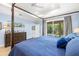 Spacious main bedroom with wood floors, a large window with outdoor views, and ensuite access at 2623 57Th S St, Gulfport, FL 33707