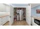 Walk-in pantry with ample shelving and a stainless steel refrigerator at 2623 57Th S St, Gulfport, FL 33707
