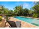 Backyard features a sparkling pool, lush landscaping, and plenty of lounge seating at 2623 57Th S St, Gulfport, FL 33707