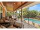 Inviting covered outdoor living area featuring comfortable seating that overlooks the pool at 2623 57Th S St, Gulfport, FL 33707