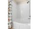Bathroom showcasing a tub with a shower head and colorful shower curtain at 26517 Castleview Way, Wesley Chapel, FL 33544