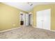 A bedroom featuring neutral-colored walls, carpeted floors, and access to a walk-in closet and bathroom at 26517 Castleview Way, Wesley Chapel, FL 33544