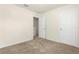 This is a bedroom with neutral walls, carpet, and doors at 26517 Castleview Way, Wesley Chapel, FL 33544