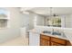 Well-lit kitchen with stainless steel sink, modern appliances, and white dishwasher at 26517 Castleview Way, Wesley Chapel, FL 33544