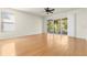 Spacious living room with wood floors, neutral walls, ceiling fan, and lots of natural light at 26517 Castleview Way, Wesley Chapel, FL 33544