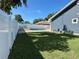 Fenced backyard with a refreshing pool, lounge chairs, and green grass at 3000 Tangerine Ter, Palm Harbor, FL 34684