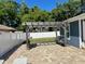 Backyard patio with pergola, outdoor seating, and a privacy fence at 3000 Tangerine Ter, Palm Harbor, FL 34684