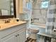 This bathroom features a shower-tub combo and a vanity with plenty of storage space at 3000 Tangerine Ter, Palm Harbor, FL 34684