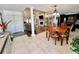 This dining area flows into the living room and features an elegant light fixture at 3000 Tangerine Ter, Palm Harbor, FL 34684