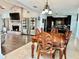 Open-concept dining room with elegant wood table and access to living room and kitchen, perfect for entertaining at 3000 Tangerine Ter, Palm Harbor, FL 34684