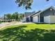 Charming home with an attached garage, lush lawn, and a well-maintained brick driveway for added curb appeal at 3000 Tangerine Ter, Palm Harbor, FL 34684