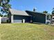 Rear exterior of the house showing the roof and a fenced backyard at 3000 Tangerine Ter, Palm Harbor, FL 34684