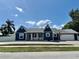 Inviting single story home with garage, white picket fence, manicured lawn, and brick driveway for a beautiful curb appeal at 3000 Tangerine Ter, Palm Harbor, FL 34684