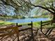Scenic view of Lake Valencia from the park with a wooden fence at 3000 Tangerine Ter, Palm Harbor, FL 34684