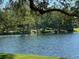 Beautiful lake view with a gazebo in the distance adding charm to the serene water landscape and lush greenery at 3000 Tangerine Ter, Palm Harbor, FL 34684