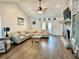 Bright living room showcasing vaulted ceilings, wood floors, a brick fireplace, and an open floorplan at 3000 Tangerine Ter, Palm Harbor, FL 34684