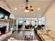 Bright and spacious living room featuring a brick fireplace and open layout to the dining area at 3000 Tangerine Ter, Palm Harbor, FL 34684