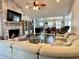 Bright and spacious living room featuring a brick fireplace and open layout to the dining area at 3000 Tangerine Ter, Palm Harbor, FL 34684