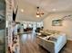 Cozy living room featuring vaulted ceilings, wood floors, a brick fireplace, and an open floorplan at 3000 Tangerine Ter, Palm Harbor, FL 34684