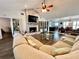 Inviting living room featuring a brick fireplace, vaulted ceilings, an open floorplan, and ample natural light at 3000 Tangerine Ter, Palm Harbor, FL 34684