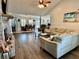 Spacious living room featuring vaulted ceiling, wood floors, a brick fireplace, and an open floorplan at 3000 Tangerine Ter, Palm Harbor, FL 34684